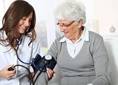 Home health aide takes blood pressure of an elderly woman in Delray Beach, FL