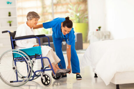 Companion Caregiver in Palm Beach Gardens helping an elderly woman in a wheelchair